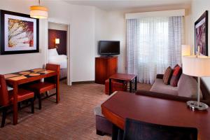 a hotel room with a living and dining room at Residence Inn by Marriott Tallahassee Universities at the Capitol in Tallahassee