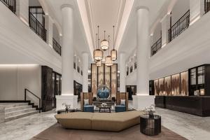 a lobby with a couch in the middle of a building at Courtyard by Marriott Phuket Town in Phuket Town