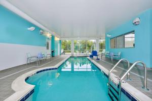 a swimming pool in a building with a blue wall at SpringHill Suites Ashburn Dulles North in Ashburn