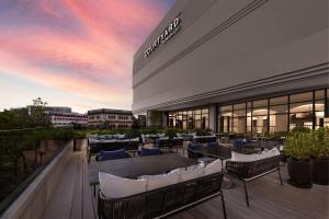 a patio with tables and chairs on a building at Courtyard by Marriott Phuket Town in Phuket Town