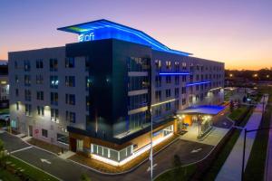 an image of the hotel at night at Aloft Gainesville University Area in Gainesville