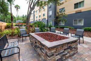 a patio with chairs and a fire pit in a courtyard at Fairfield Inn and Suites St Petersburg Clearwater in Clearwater