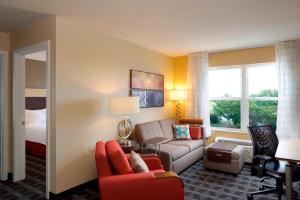 a hotel room with a couch and a bed at TownePlace Suites by Marriott Jacksonville in Jacksonville