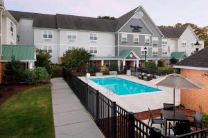 a hotel with a swimming pool in front of a building at TownePlace Suites by Marriott Jacksonville in Jacksonville
