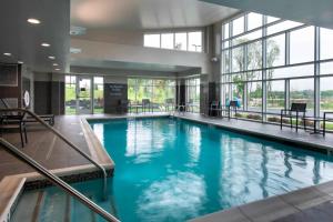 a large pool with blue water in a building at Residence Inn by Marriott Lancaster in Lancaster