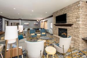 uma sala de estar com lareira e cadeiras em TownePlace Suites by Marriott Tucson Williams Centre em Tucson
