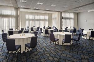 a conference room with tables and chairs and tablesktop at Courtyard by Marriott New Carrollton Landover in Landover