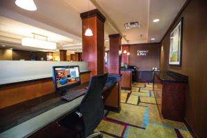 a lobby with a desk with a laptop on it at Fairfield Inn & Suites Toledo North in Toledo