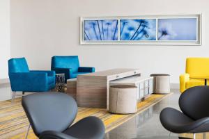 a waiting room with blue chairs and a table at Residence Inn by Marriott San Diego Downtown/Bayfront in San Diego