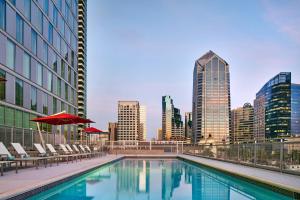 a swimming pool with chairs and a city skyline at Residence Inn by Marriott San Diego Downtown/Bayfront in San Diego