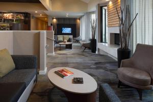 a lobby of a hotel with a couch and a table at Courtyard St. Louis Creve Coeur in Creve Coeur