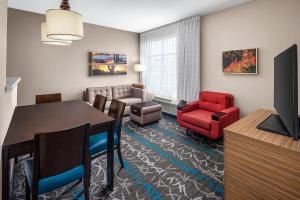 a living room with a dining room table and chairs at TownePlace Suites by Marriott Big Spring in Big Spring