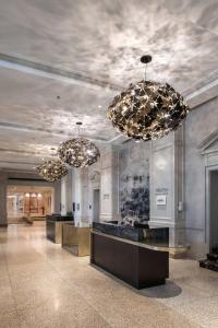 a lobby with three chandeliers in a building at The Westin Nova Scotian in Halifax