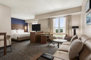 a hotel room with a bed and a couch at Residence Inn Houston Northwest / Willowbrook in Houston