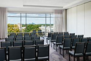 a row of chairs in a room with windows at AC Hotel By Marriott Raleigh Downtown in Raleigh
