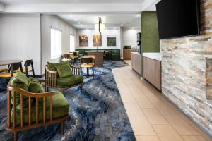 a hotel room with a lobby with a dining room at Fairfield Inn & Suites by Marriott Tulsa Central in Tulsa