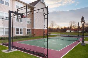 a tennis court in front of a house at Residence Inn Cranbury South Brunswick in Cranbury