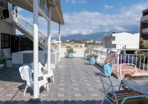 a patio with chairs and tables on a building at Hotel El Olimpo in Santa Marta