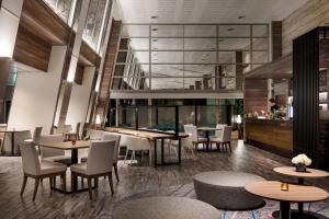 a restaurant with tables and chairs and a bar at Lake Biwa Marriott Hotel in Moriyama