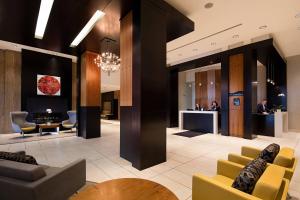a lobby of a hotel with chairs and a table at Delta Hotels by Marriott Edmonton South Conference Centre in Edmonton
