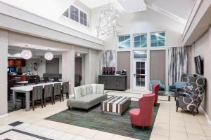 a large living room with chairs and a table at Residence Inn Jackson Ridgeland in Ridgeland