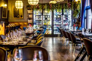 a restaurant with tables and chairs with wine glasses at Scandic Palace Hotel in Copenhagen