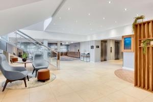 an office lobby with chairs and a staircase at Radisson Hotel York in York