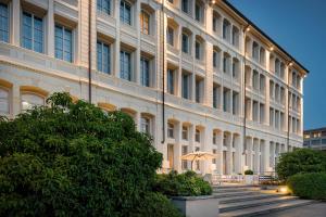 un gran edificio con una sombrilla delante de él en AC Hotel Torino by Marriott en Turín