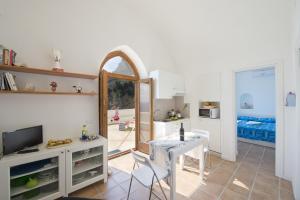 a living room with a table and a mirror at La Scivitella in Amalfi