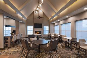 a dining room with tables and chairs and a fireplace at Residence Inn by Marriott Austin The Domain Area in Austin