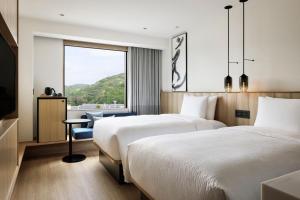 A bed or beds in a room at Fairfield by Marriott Hyogo Awaji Fukura