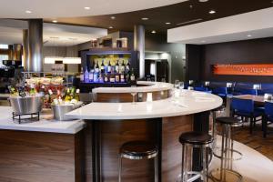 a bar in a restaurant with stools and a counter at Courtyard by Marriott Galveston Island in Galveston