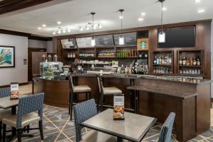 a bar in a restaurant with tables and chairs at Courtyard by Marriott Abilene Northeast in Abilene