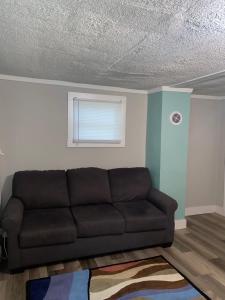 a living room with a couch and a window at Cute 1 Bdrm House that sleeps 3 in Petersburg