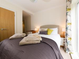a bedroom with a bed with towels on it at Lower Chine Apartment in Shanklin