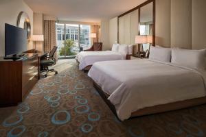 a hotel room with two beds and a flat screen tv at Marriott Marquis Washington, DC in Washington