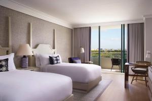 a hotel room with two beds and a balcony at The Ritz-Carlton Coconut Grove, Miami in Miami