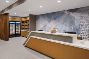 a lobby of a store with a checkout counter at SpringHill Suites by Marriott Tuckahoe Westchester County in Tuckahoe