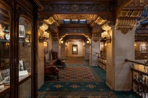 an ornate hallway with a library with bookshelves at The Historic Davenport, Autograph Collection in Spokane