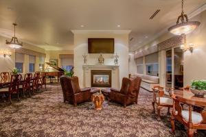 a living room with a fireplace and a table and chairs at The Historic Davenport, Autograph Collection in Spokane