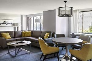 a living room with a couch and a table and chairs at San Francisco Marriott Fisherman's Wharf in San Francisco