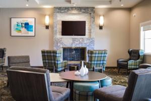 a waiting room with chairs and a fireplace at Residence Inn La Mirada Buena Park in La Mirada