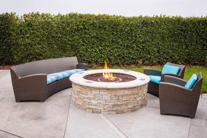 two chairs and a fire pit in a patio at Residence Inn La Mirada Buena Park in La Mirada