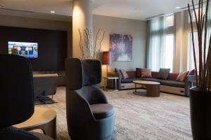 a lobby with a waiting room with couches and chairs at Courtyard by Marriott Morgantown in Morgantown