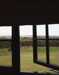 a view of a field of grass from a window at The Winford Retreat in Winford