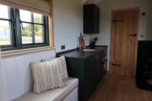 a kitchen with a black counter and a window at The Winford Retreat in Winford