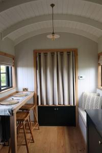 a room with a kitchen with a table and a window at The Winford Retreat in Winford