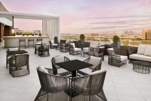 a patio with tables and chairs and a bar at Courtyard by Marriott World Trade Centre, Dubai in Dubai