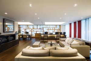 a large living room with couches and a fireplace at Marriott Executive Apartment Seoul in Seoul