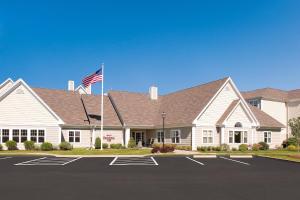 a house with an american flag in front of it at Residence Inn New Bedford Dartmouth in North Dartmouth